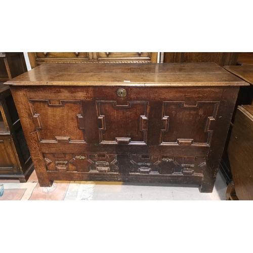606 - An 18th century oak mule chest with geometric moulded decoration hinged lid, and 2 lower drawers, on... 
