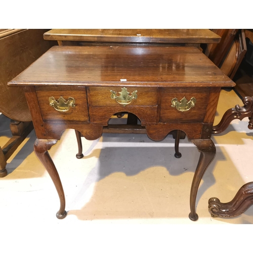 651 - An 18th century country made oak low boy with 3 frieze drawers and shaped apron, on cabriole legs, w... 
