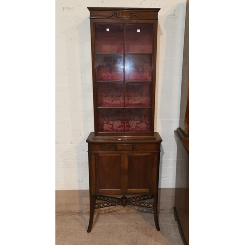 667 - An Edwardian mahogany full height display cabinet with single astragal glazed door over double doors... 