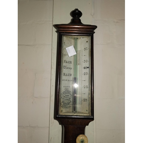 563 - A Georgian marine barometer in mahogany case, with thermometer, having silvered dial, brass base and... 