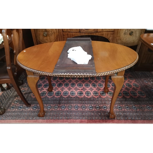582 - A period style mahogany wind out dining table, the oval top with gadrooned border, on ball and claw ... 
