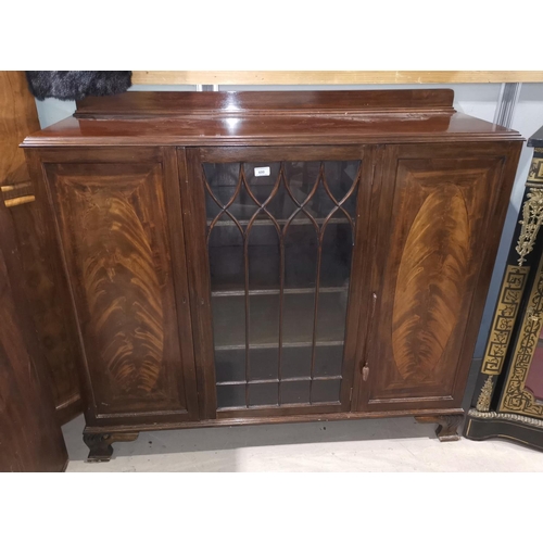 600 - A 1930's figured mahogany side cabinet with 2 panelled and central glazed doors, width 127 cm