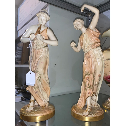 188 - A late 19th century pair of Royal Worcester figures of classical women, one playing the pipes and on... 