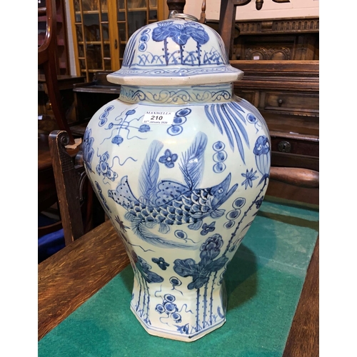 210 - A 20th century Chinese large octagonal covered vase of inverted baluster form decorated in blue & wh... 