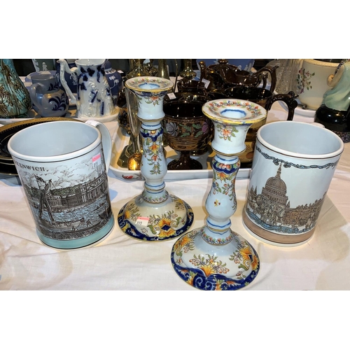 227 - A continental pair of faience candlesticks, 21 cm; a pair of Shand Kydd pottery mugs decorated with ... 