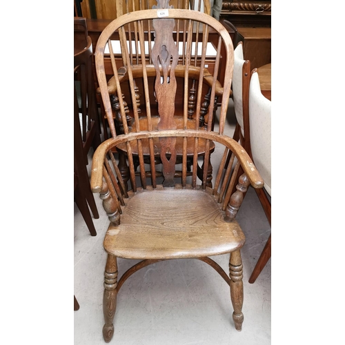 624 - A 19th century elm Windsor armchair with solid seat and crinoline stretcher