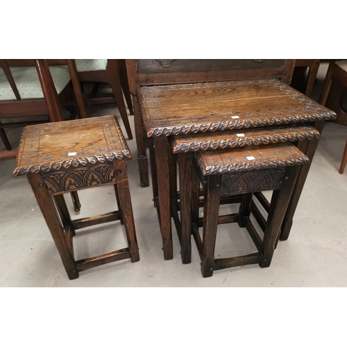 682 - A Jacobean style nest of 4 occasional tables in carved oak