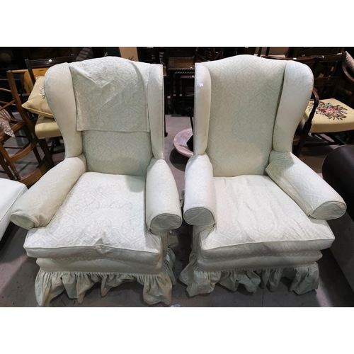 685 - An early 20th century pair of wing back armchairs, reupholstered in cream and green fabric; a simila... 