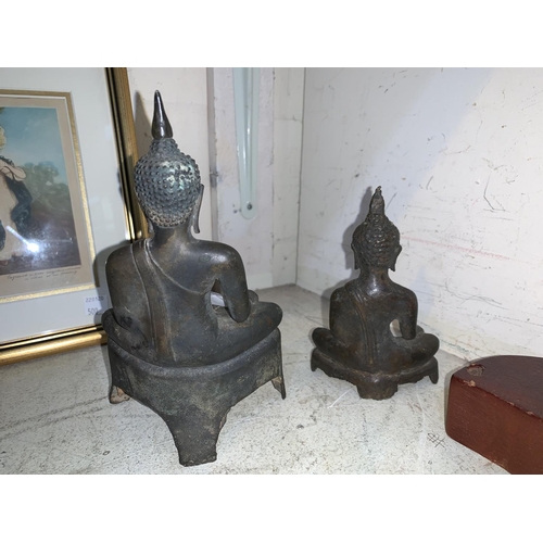 498 - A far eastern bronze figure of Buddha, 20 cm, later wooden stand; a similar smaller figure, 14 cm
