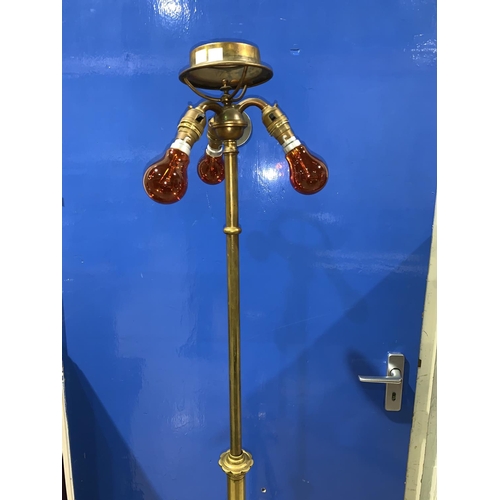 661 - A wrought brass standard lamp with triple electric light fitting, height 164 cm