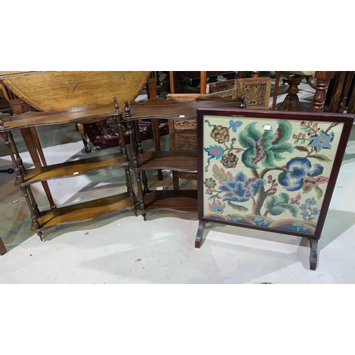 692 - Two reproduction mahogany wall hanging whatnots; a similar wine table; a needlework firescreen