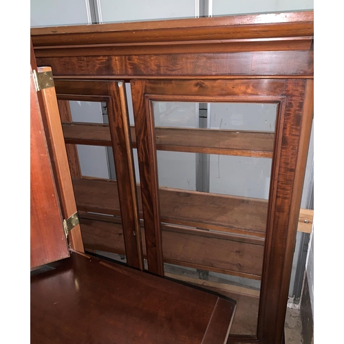704 - A mahogany bookcase with double doors (1 glass door missing)