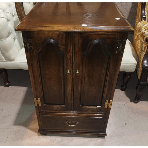 696a - A Reprodux golden oak cabinet with double arch panel doors and hinged lid over single drawer