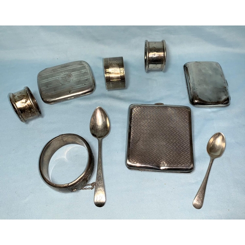 303 - Three hallmarked silver cigarette cases (a.f.); 3 napkin rings; 2 spoons; a bangle, 11.5 ozt
