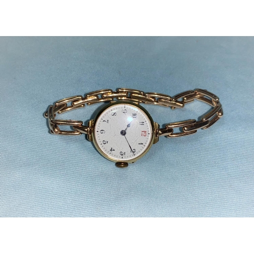 366 - An early 20th century wristwatch in 18 carat gold case, with Arabic numerals on white enamel backgro... 