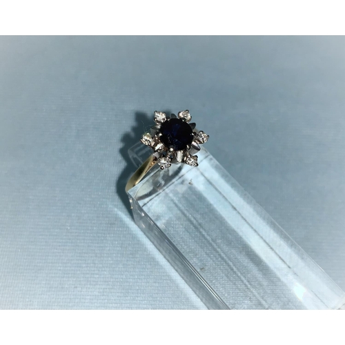 409 - A dress ring set sapphire and diamonds, the shank marked '18 ct'