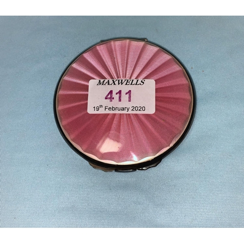 411 - A circular compact in hallmarked silver and pink enamel