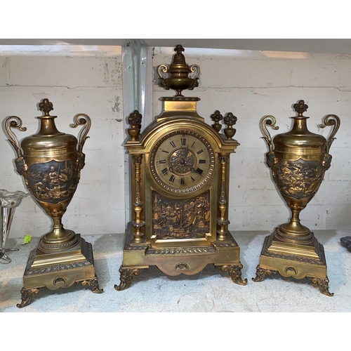 501 - A 19th century French clock garniture in gilt bronze decorated with panels of historical scenes, the... 