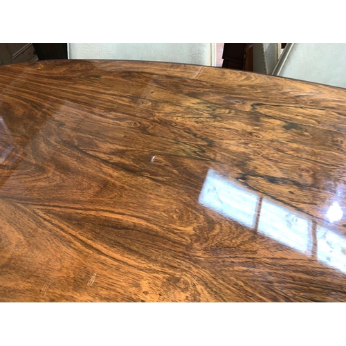 651 - A large mid-20th century oval extending rosewood pedestal dining table in the manner of Archie Shine... 