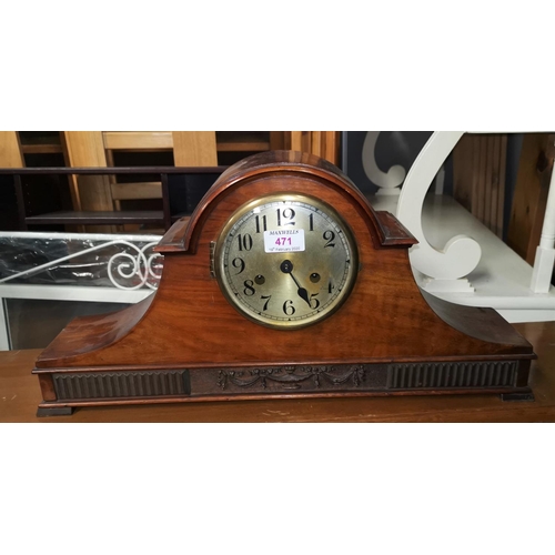 471 - A 1920's striking mantel clock in walnut arch top case