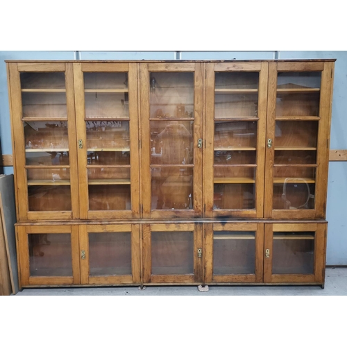 570 - A large oak library bookcase with 10 glazed doors, width 298 cm, height 218 cm