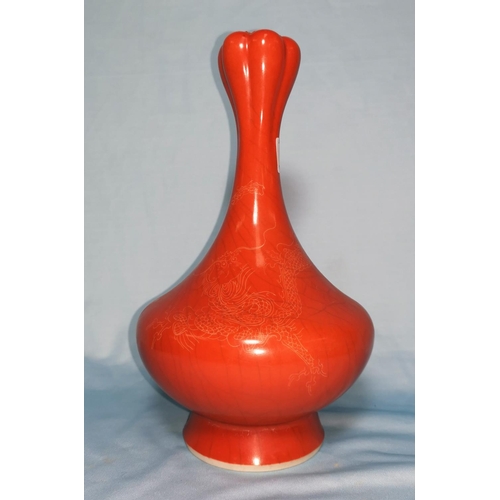 109 - A Chinese porcelain vase with crazed orange enamel glaze, dragon decoration, 15 cm