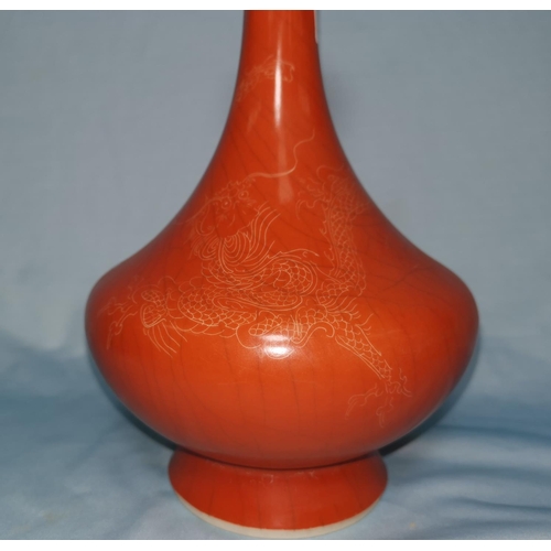 109 - A Chinese porcelain vase with crazed orange enamel glaze, dragon decoration, 15 cm