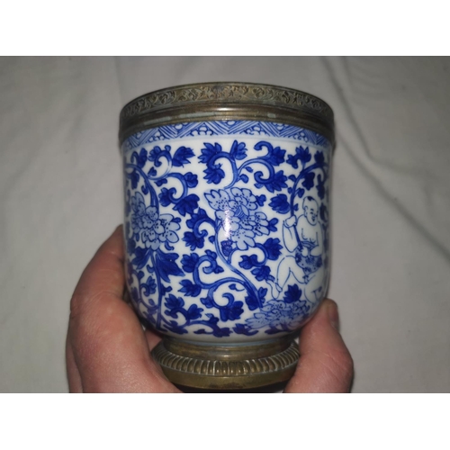 111B - A Chinese Kangxi period vase decorated in blue and white with figures, copper rim and pedestal foot,... 