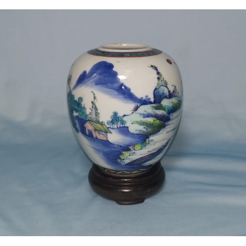 109C - A Chinese vase decorated with polychrome scenes, on wooden stand, height of vase 10cm
