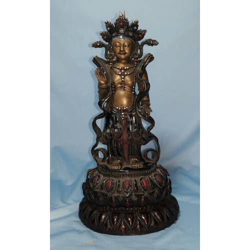 125b - An oriental ceramic figure of Buddha decorated in gilt, etc., on wooden stand