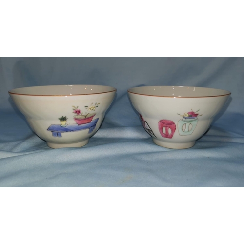 126b - A Chinese pair of ceramic tea bowls with polychrome decoration, marks to base