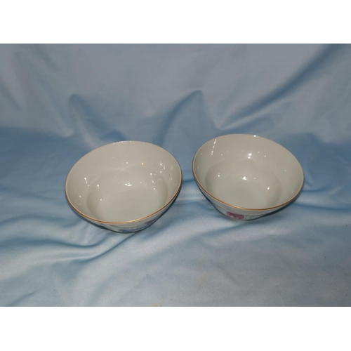 126b - A Chinese pair of ceramic tea bowls with polychrome decoration, marks to base