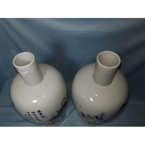 127C - A pair of Chinese blue and white inverted balaster vases with red highlights to the figures and char... 