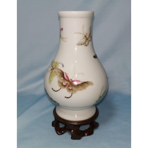 128B - A small Chinese baluster vase decorated with polychrome butterflies, six character mark to base