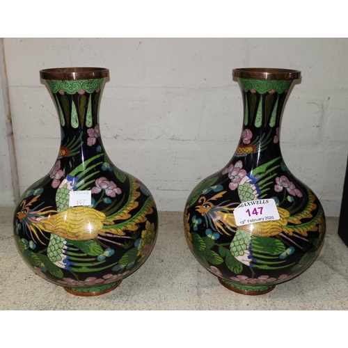 147 - A Chinese pair of cloisonné bulbous vases decorated with dragons, 21 cm