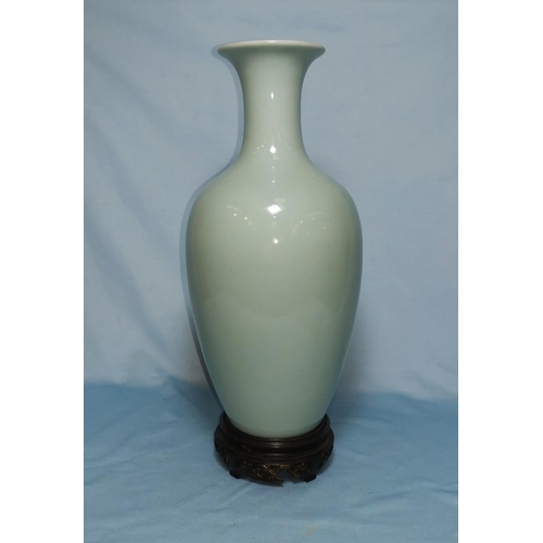 154A - A Chinese celadon balaster case with flared rim with mark to base 27cm on wooden stand