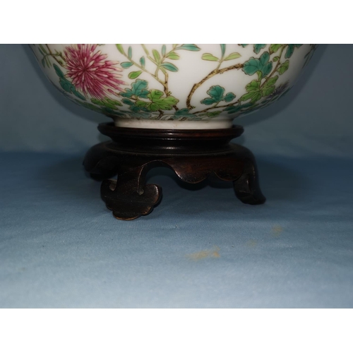 154C - A Chinese famile vert bowl on stand with bird decoration with six character mark to base diameter 13... 