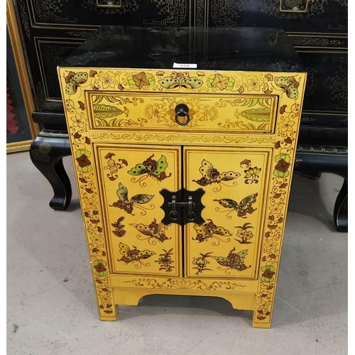 158 - An oriental small cabinet, black and yellow lacquer, with double door and frieze drawer, height 60 c... 