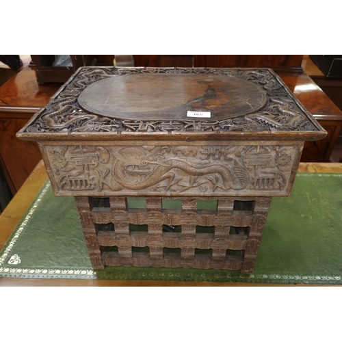 165 - A Chinese wooden scholar's desk ornately carved with dragons and characters, 49 x 36 x 36cm