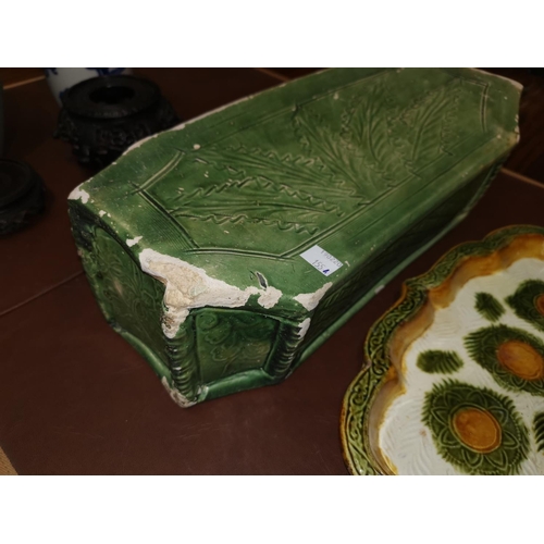 155A - An antique Chinese stone pillow in green and a similar stoneware Chinese dish