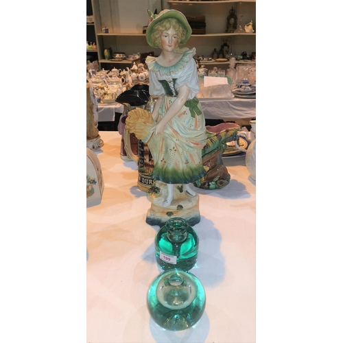 199 - Two green glass dumpy paper weights; a large bisque figure of a framer