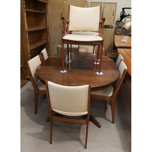 576 - A mid 20th Scandinavian  dining suite comprising rosewood table with 2 extending leaes and 8 chairs,... 