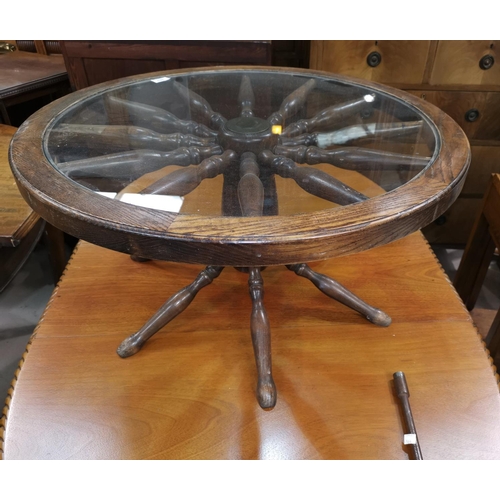 628 - A coffee table in the form of a ship's wheel, with glass top
