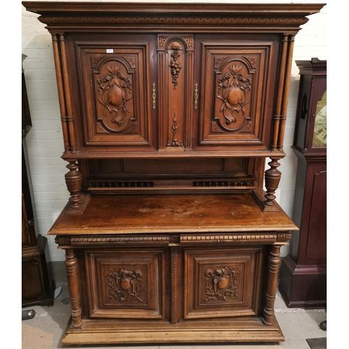 640 - An early 20th century French Provincial full height cabinet in stained wood, the upper and lower sec... 