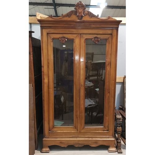641 - A French Provincial walnut full height side cabinet with carved crest and 2 glazed doors, height 260... 