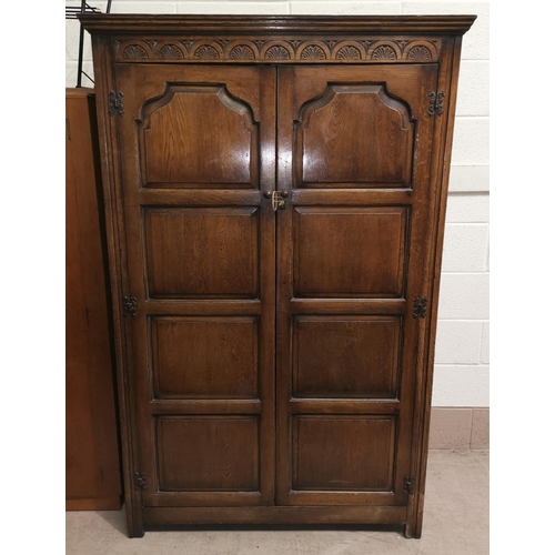 661 - A 1930's oak double door wardrobe with carved panel doors