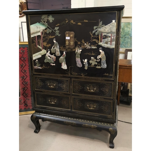157 - A mid 20th century Chinese/Japanese side cabinet, black lacquered with extensive raised coloured sto... 