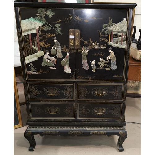 157 - A mid 20th century Chinese/Japanese side cabinet, black lacquered with extensive raised coloured sto... 