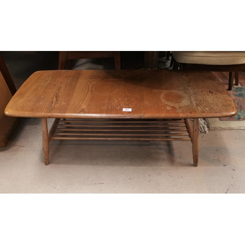 582 - An Ercol light elm coffee table with rectangular top and undertier