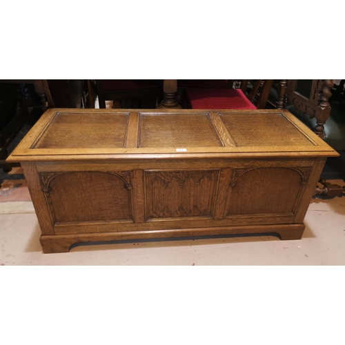 618 - A 1930's golden oak chest with panel front and hinged lid, 122 cm x 48 cm x 4 cm